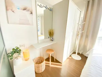 a small white room with a mirror and a stool at Luxury Condo Near Patong Beach & Shopping Mall in Kathu
