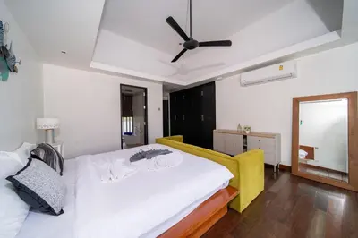 a bedroom with two beds and a ceiling fan at Bang Tao 6-bedroom large private pool modern Balinese style leisure holiday villa BBQ family group the park in Bang Tao Beach