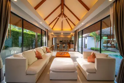 a living room with white furniture and large windows at BangTao Anchan \u8c6a\u534e\u4e24\u5367 \u79c1\u4eba\u6cf3\u6c60 \u73b0\u4ee3\u5ea6\u5047\u5df4\u5398\u98ce in Layan Beach