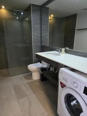 a bathroom with a washing machine and a sink at Sea Side Haven 1 Bed T2-621 in Phuket Town
