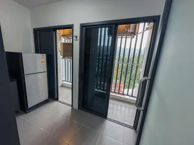 a hallway with sliding glass doors and a refrigerator at Beachside Bliss 2- Bed HM612 in Phuket Town
