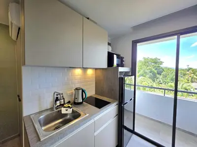 a small kitchen with a sink and a window at Island Drift Studio T3-332 in Chalong