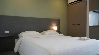 a bedroom with a large white bed with two pillows at Palm Bay Studio T3 -532 in Phuket Town