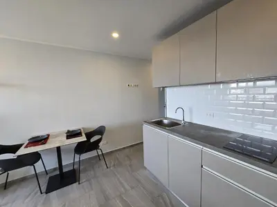 a kitchen with a sink and a table and chairs at Urban Tide Studio T3 -626 in Chalong