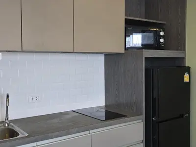 a kitchen with a black refrigerator and a sink at Urban Tide Studio T3 -626 in Chalong