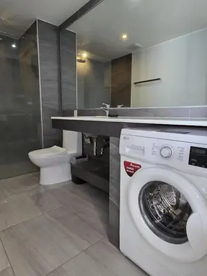 a bathroom with a washing machine and a sink at Skyline Serenity 1Bed T2-721 in Phuket Town