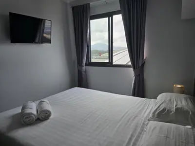a bedroom with a white bed with a window at 1 BR Condo in good location NV402 in Phuket Town