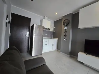 a kitchen with a stainless steel refrigerator and white cabinets at 1 BR Condo in good location NV402 in Phuket Town