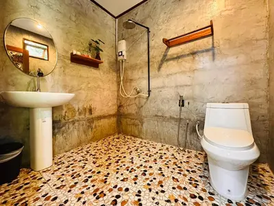 a bathroom with a shower and a toilet and a sink at Bangalow Coconut corner in Ban Laem Sai