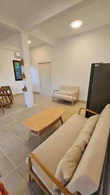 a room with benches and a table and a couch at Tropical 1BR Bungalow in Rawai with Shared Pool in Nai Harn Beach