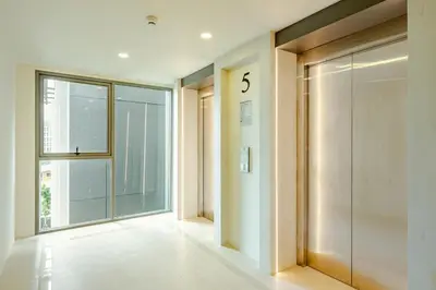 a hallway with a large glass door and a large window at The Ozone Condominium 513 One-Bedroom Apartment in Laguna Phuket