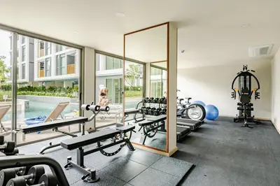 a fitness room with a mirror and a gym at The Ozone Condominium 513 One-Bedroom Apartment in Laguna Phuket