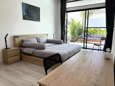 a bedroom with a bed and a large window at Villa Anthoni - Cozy 3 bedrooms with pool in Rawai Beach