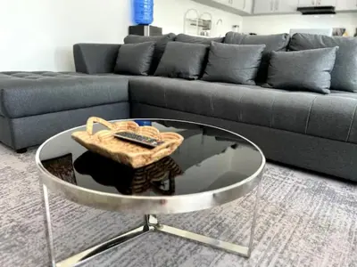a living room with a couch and a glass table at Villa Lola - Modern 3 Bedrooms Villa with Pool in Ban Saiyuan (1)