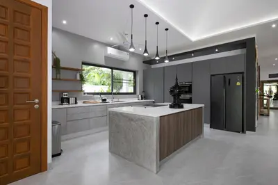 a large kitchen with a large island in the middle at Villa Matara - Large & Stylish 5 Bedrooms with Pool in Rawai Beach