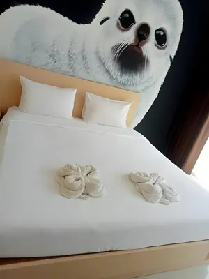 a bed with a cat head and two cookies on it at GO INN Krabi Ao Nang Beach - โกอินน์ อ่าวนาง in Ban Khlong Haeng