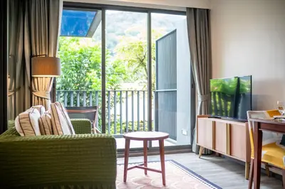 a living room with a couch and a table and a balcony at \u8d85\u4f18\u60e0 43\u82ad\u4e1c\u6d77\u6ee9\u7cbe\u88c5\u516c\u5bd3 5\u5206\u949f\u6d77\u6ee910\u5206\u949f\u9152\u5427\u8857 \u65c5\u884c\u5ea6\u5047\u9996\u9009 in Patong Beach