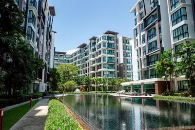 a river in a city with tall buildings at Royal Lee Airport Phuket in Ban Bo Han