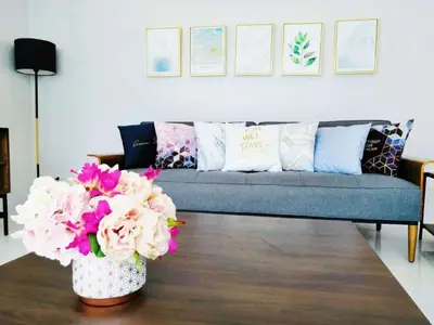 a living room with a couch and flowers on a table at 3bedrooms pool Villa in Kamala in Kamala Beach
