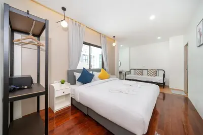 a bedroom with a large white bed and a desk at 7BR Patong pool villa in Patong Beach