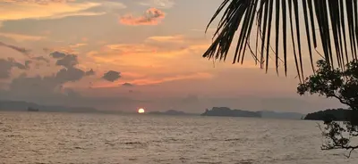 a sunset over the water with islands in the distance at Krabi Sea view, Lilly Beach Room Balibar in Krabi town