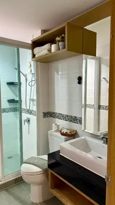 a bathroom with a toilet and a sink and a shower at Apartment with a view near the park in Ban Rangeng