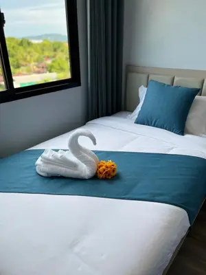 a swan made out of towels on a bed at UPMOON Hotel Chalong Phuket in Ban Suan