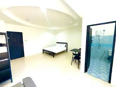 a room with a bed and a bathroom with a shower at Patong Canal Villa 102 in Patong Beach