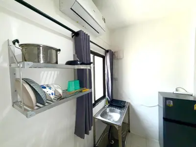 a small kitchen with a sink and a shelf at Patong Canal Villa 102 in Patong Beach