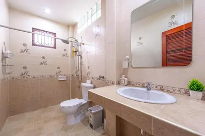 a bathroom with a sink and a toilet and a mirror at Serenity Holiday Villa 1 D Karon Beach in Karon Beach