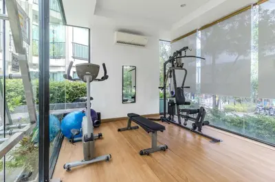 a gym with treadmills and exercise equipment in a building at C232 Prime spot Pool Gym Near Beach&Boat Ave in Bang Tao Beach