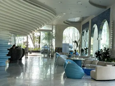 a lobby with couches and tables in a building at The Sunshine Beach 3-bedrooms Suite with Pool in Layan Beach