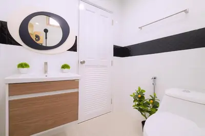 a bathroom with a toilet and a sink and a mirror at Dalbit Thai Stay 2 Bedroom Patong house - 8mins walk to Jungcyelon Bangla Rd in Patong Beach