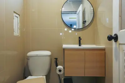 a bathroom with a toilet and a sink and a mirror at Wink Hill 4 Penthouse Patong Beach 4Beds in Patong Beach