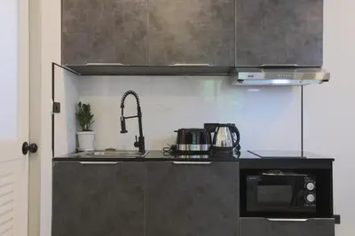 a kitchen with a sink and a microwave at Wink Hill 4 Penthouse Patong Beach 4Beds in Patong Beach