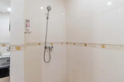 a shower with a shower head in a bathroom at C233 Condo 650m Surin 1BR with Pool &Gym Prime Location in Surin Beach