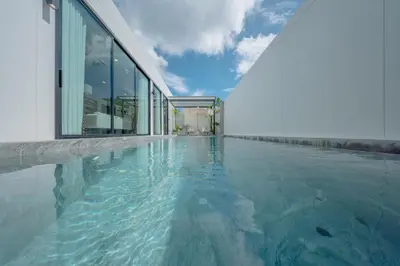 a swimming pool in front of a building at New 3BR Pool Villa w Jacuzzi Ao Nang Krabi in Ban Khlong Haeng