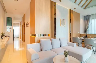 a living room with a white couch and a table at MODERN NEW RELAX VILLA SoL & PooL in Nai Yang Beach