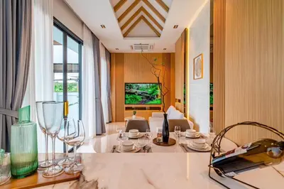 a dining room with wine glasses on a table at MODERN NEW RELAX VILLA SoL & PooL in Nai Yang Beach