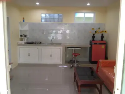 a kitchen with a sink and a table in a room at Kathu Waterfall Bungalow in Kathu