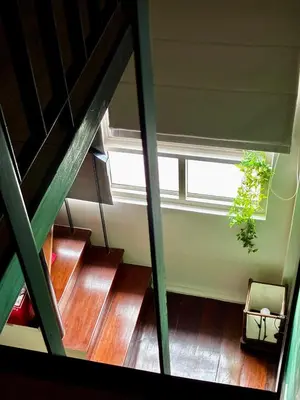 a view of a staircase with a window and a plant at Village 40 Phuket Old Town in Phuket Town