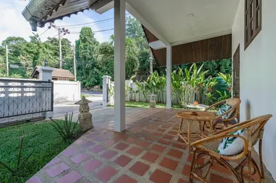 a patio with chairs and a table and a fence at Naiharn Beach Holiday Pool Villa, Rawai in Rawai Beach