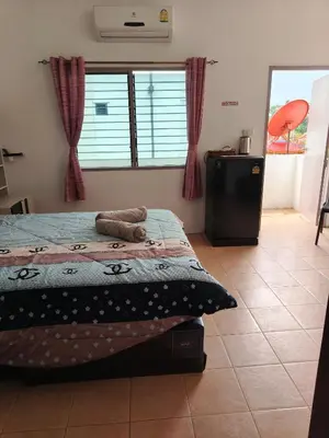 a bedroom with a bed in a room with a window at Kata beach weivs in Kata Beach