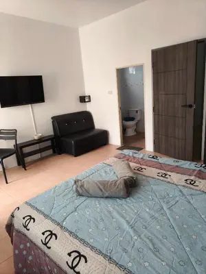 a bedroom with two beds and a couch in a room at Kata beach weivs in Kata Beach