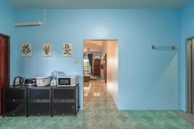 a blue room with a counter and a microwave at Areca Holiday Home 3, Karon Beach in Karon Beach