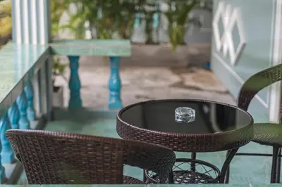 a table and chairs on a patio with a diamond engagement ring at Areca Holiday Home 3, Karon Beach in Karon Beach