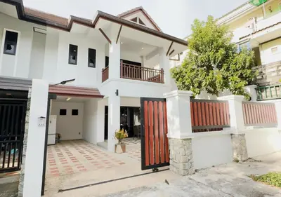 a white house with a red door at 3 Bedroom Renovated Villa 3 minutes to the beach in Karon Beach