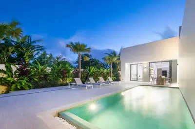 a villa with a swimming pool and a house at Luxury Modern Villa Phuket - Thala in Phuket