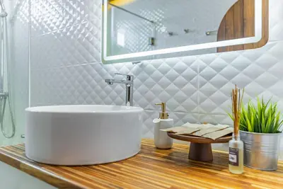 a bathroom with a large white tub on a wooden counter at Private Designer Villa with Pool Prime Rawai 3 beds in Ban Saiyuan (1)