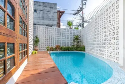 a swimming pool in the middle of a building at Private Designer Villa with Pool Prime Rawai 3 beds in Ban Saiyuan (1)